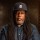 A man with dreadlocks wearing a detroit tigers cap.