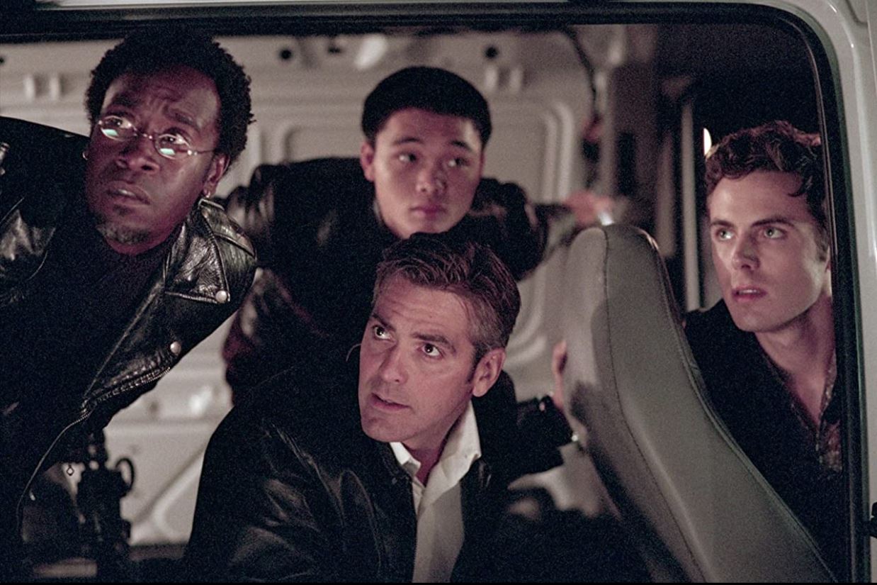Don Cheadle, George Clooney, Shaobo Qin, and Casey Affleck in a scene from 2001's Ocean's Eleven.
