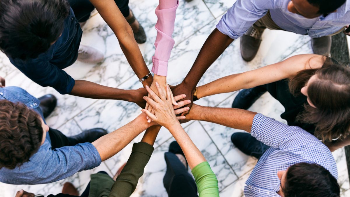 A diverse team cheer each other on.