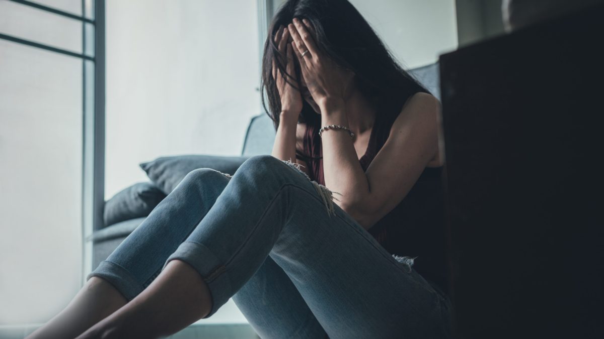 A woman suffers a panic attack alone.