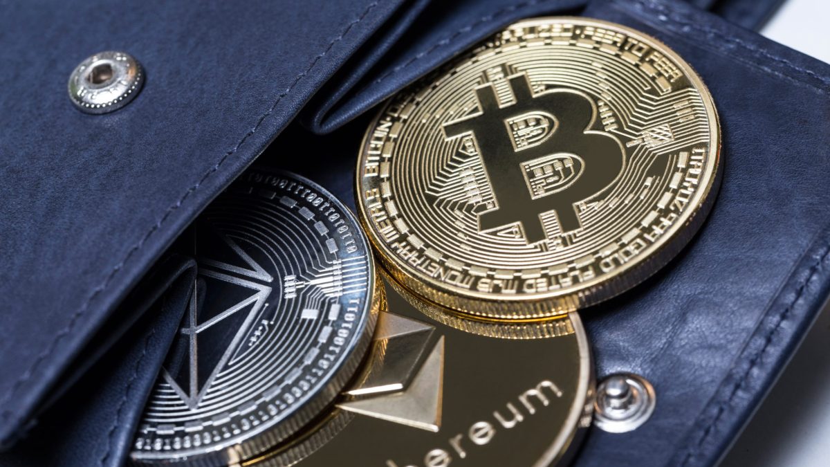 Cryptocurrency "coins" spilling out of a wallet.