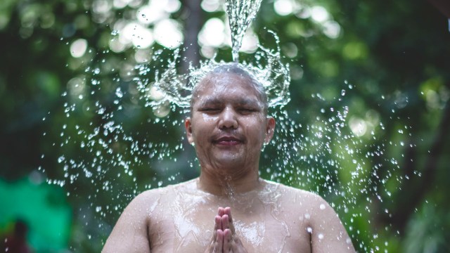 A man having a cold outdoor shower.