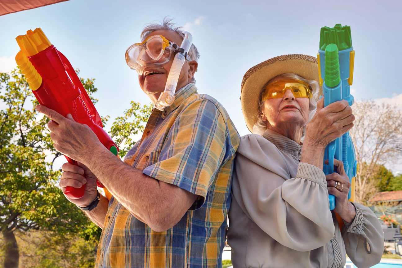 Seniors playing with water pistols.