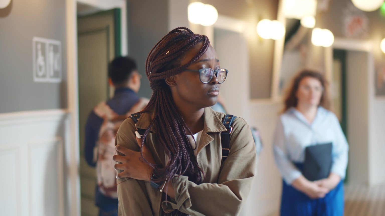 Anxious college student walking in a corridor.