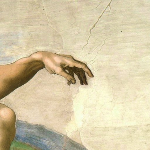 A close-up of a painted human arm and hand reaching out with extended fingers against a light, cracked background.