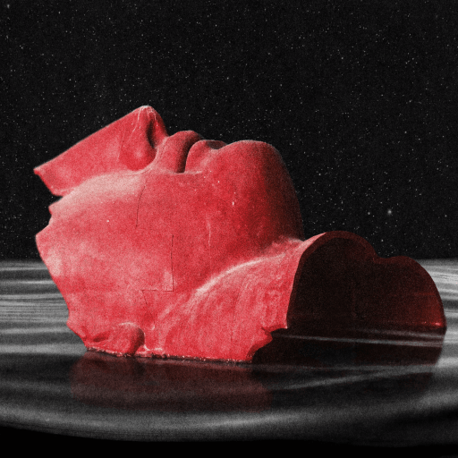 A red, fragmented sculpture of a human face is partially submerged in dark, rippling water against a black background.