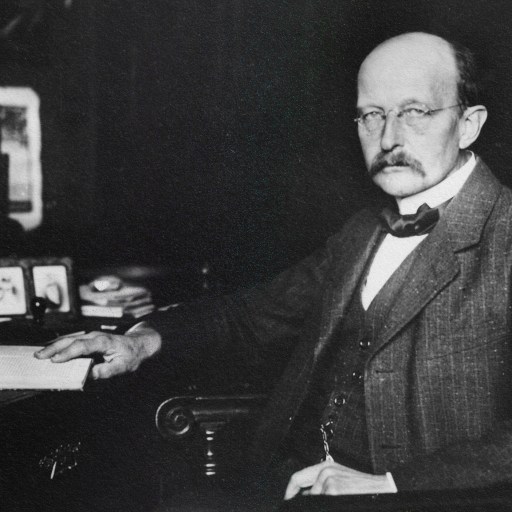 a black and white photo of a man sitting at a desk.