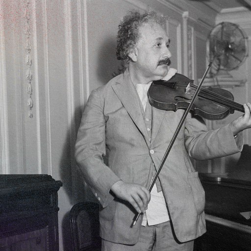 a man playing a violin in front of a piano.