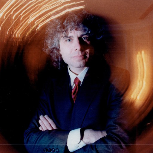 A man in a suit with crossed arms.