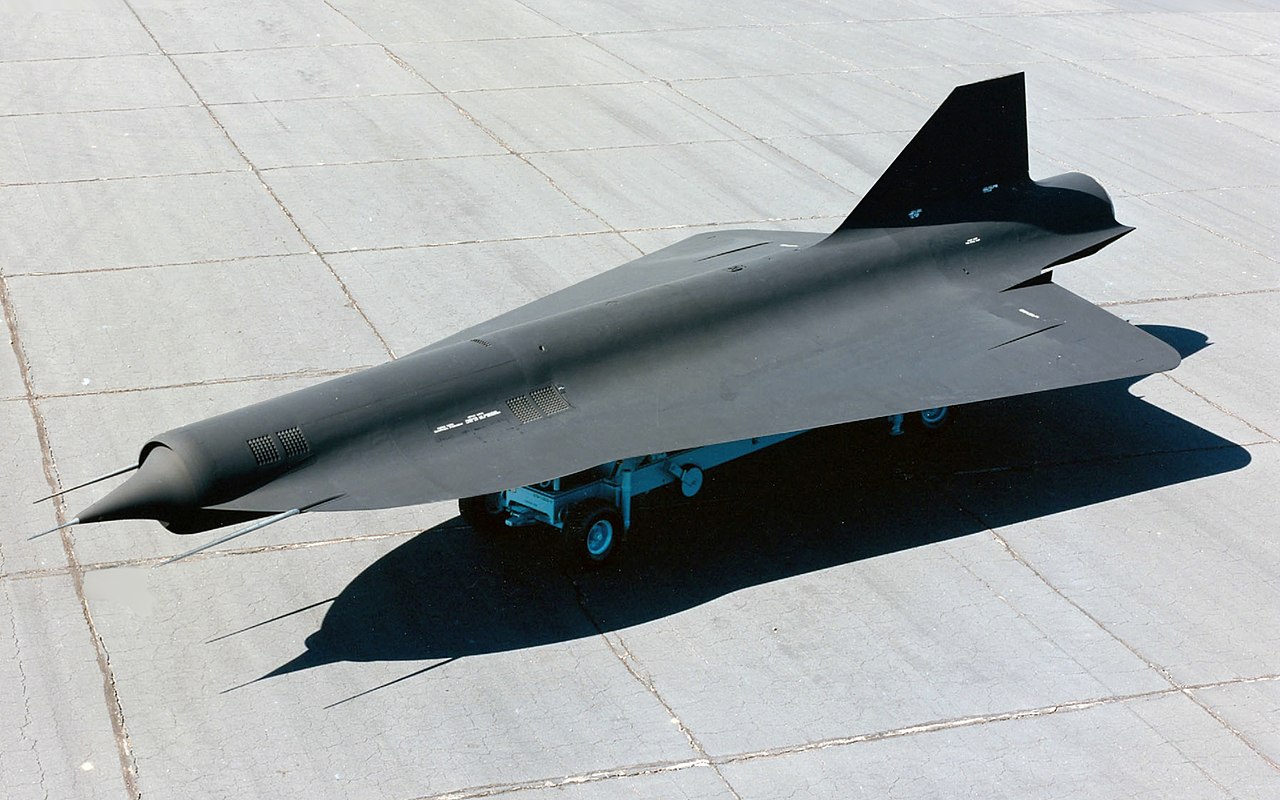 a fighter jet sitting on top of an airport tarmac.