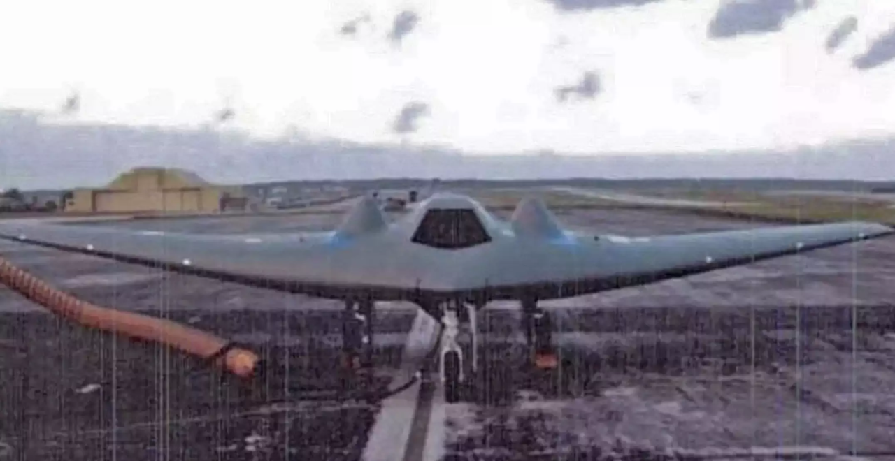 a fighter jet sitting on top of an airport tarmac.