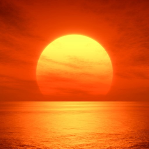 the sun is setting over the ocean on a cloudy day.