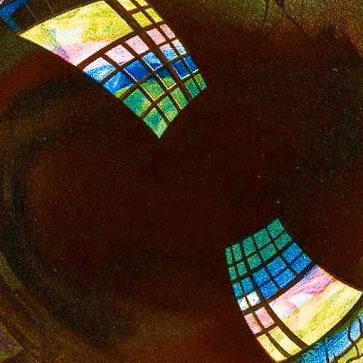 A close-up of a soap bubble reflecting bright, colorful windowpanes against a dark background.