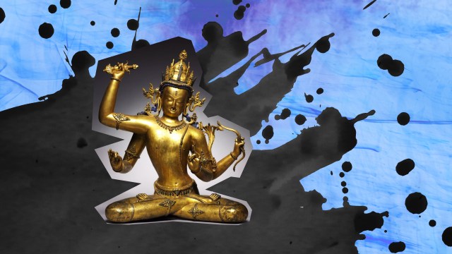 a golden statue of a person sitting in a lotus position.