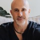 a man with a bald head wearing a black shirt.