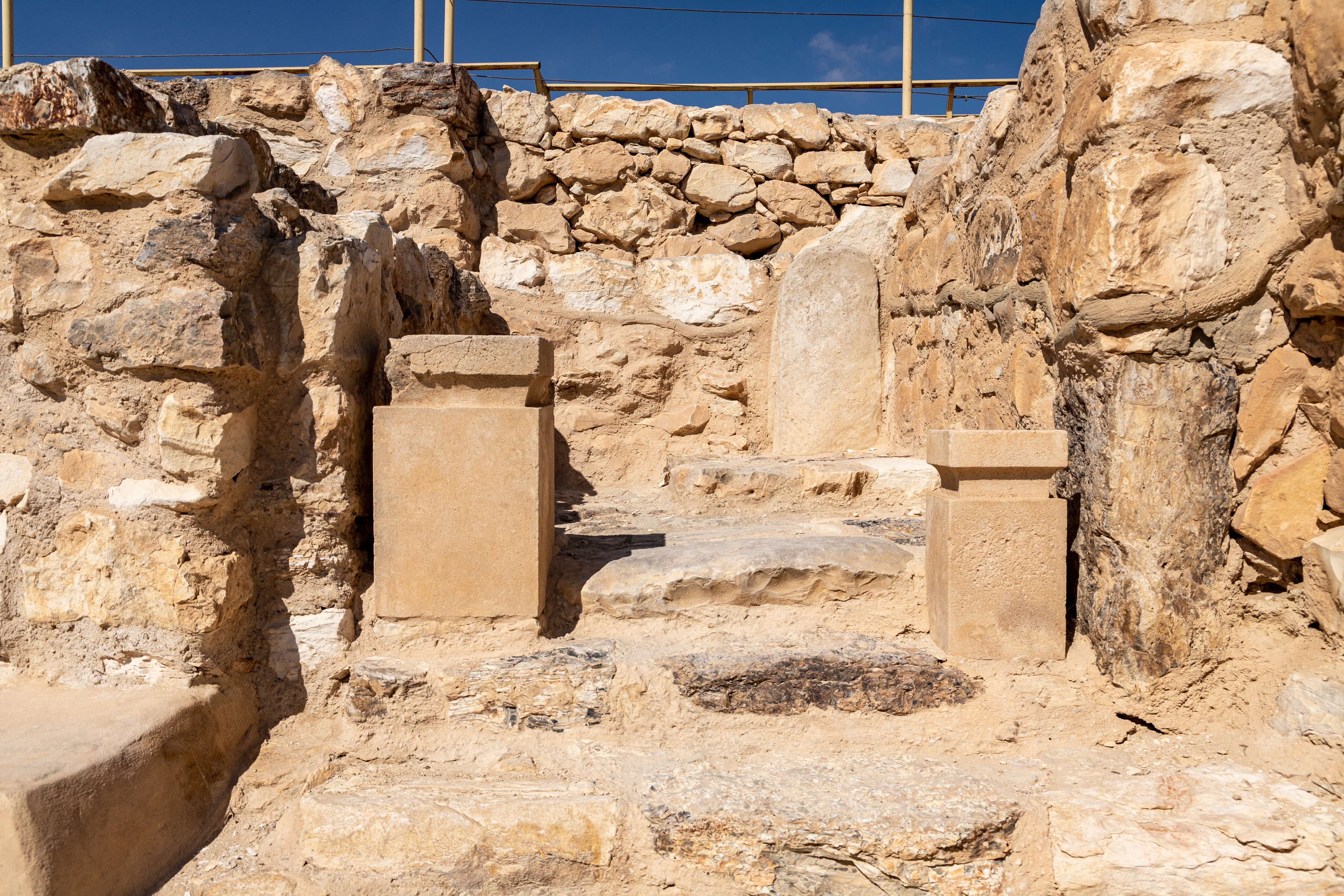 a stone structure with a bench in the middle of it.