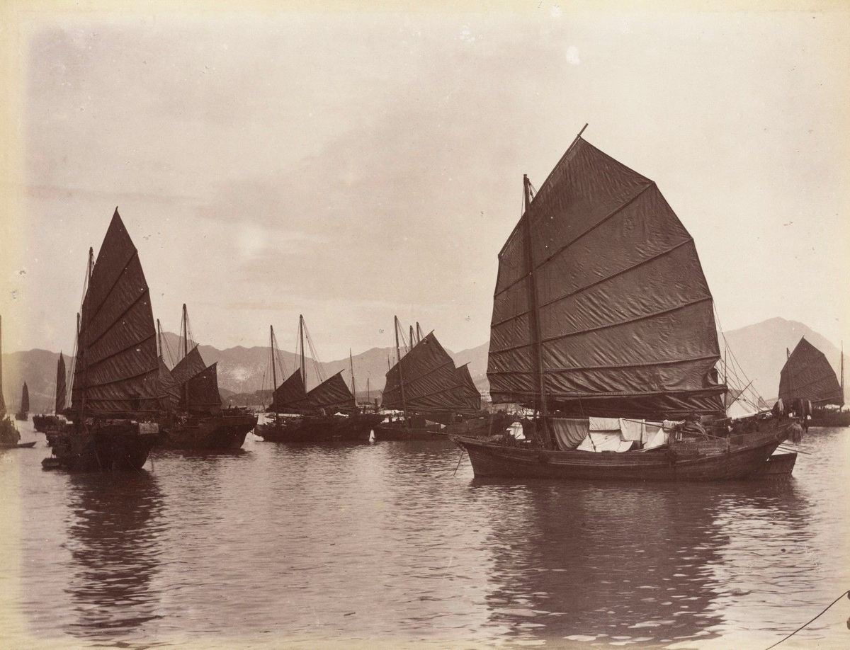 a group of sailboats floating on top of a lake.