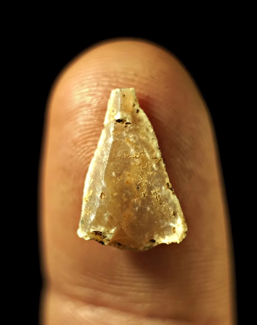 a small piece of gold on a finger.