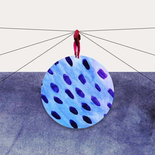 a group of people standing around a blue object.