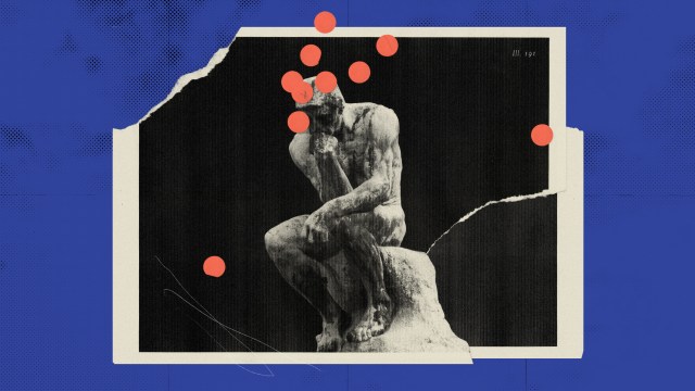 a black and white photo of a man sitting on a rock.