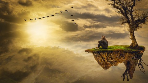 a man sitting on top of a small island.