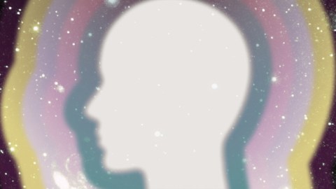 a silhouette of a person with a rainbow in the background.