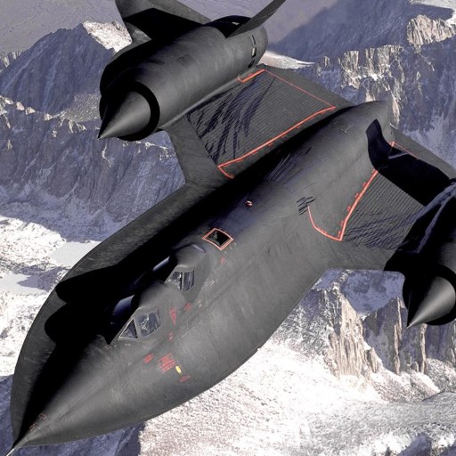 a fighter jet flying over a mountain range.
