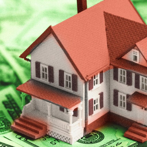 a house sitting on top of a pile of money.