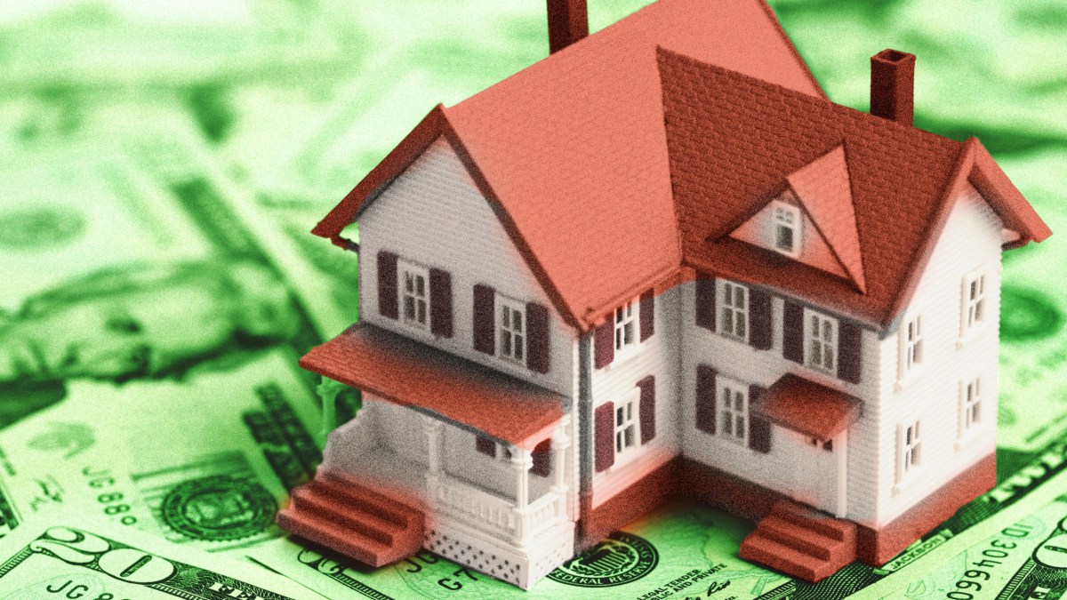 a house sitting on top of a pile of money.