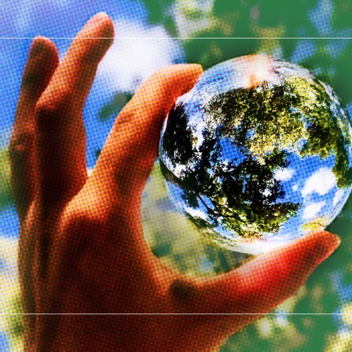 a person holding a glass ball in their hand.