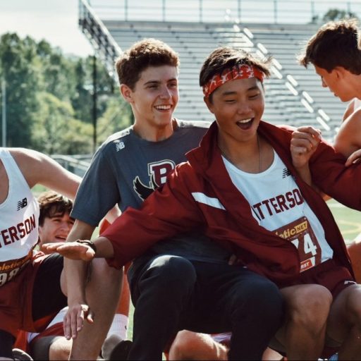 a group of young men standing next to each other on a field.