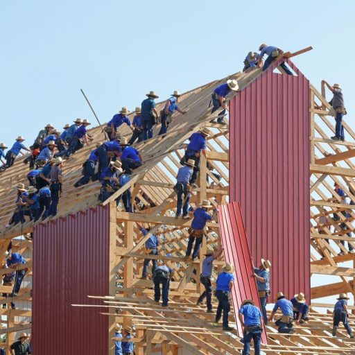 a group of men standing on top of a wooden structure.