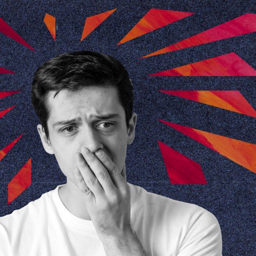 a man covers his mouth with his hands.