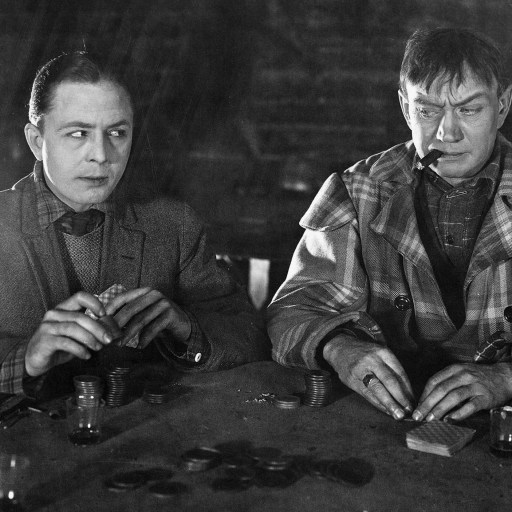 Two men engaging in a brain-teasing game at a table.