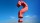 a red question mark kite flying in the sky.
