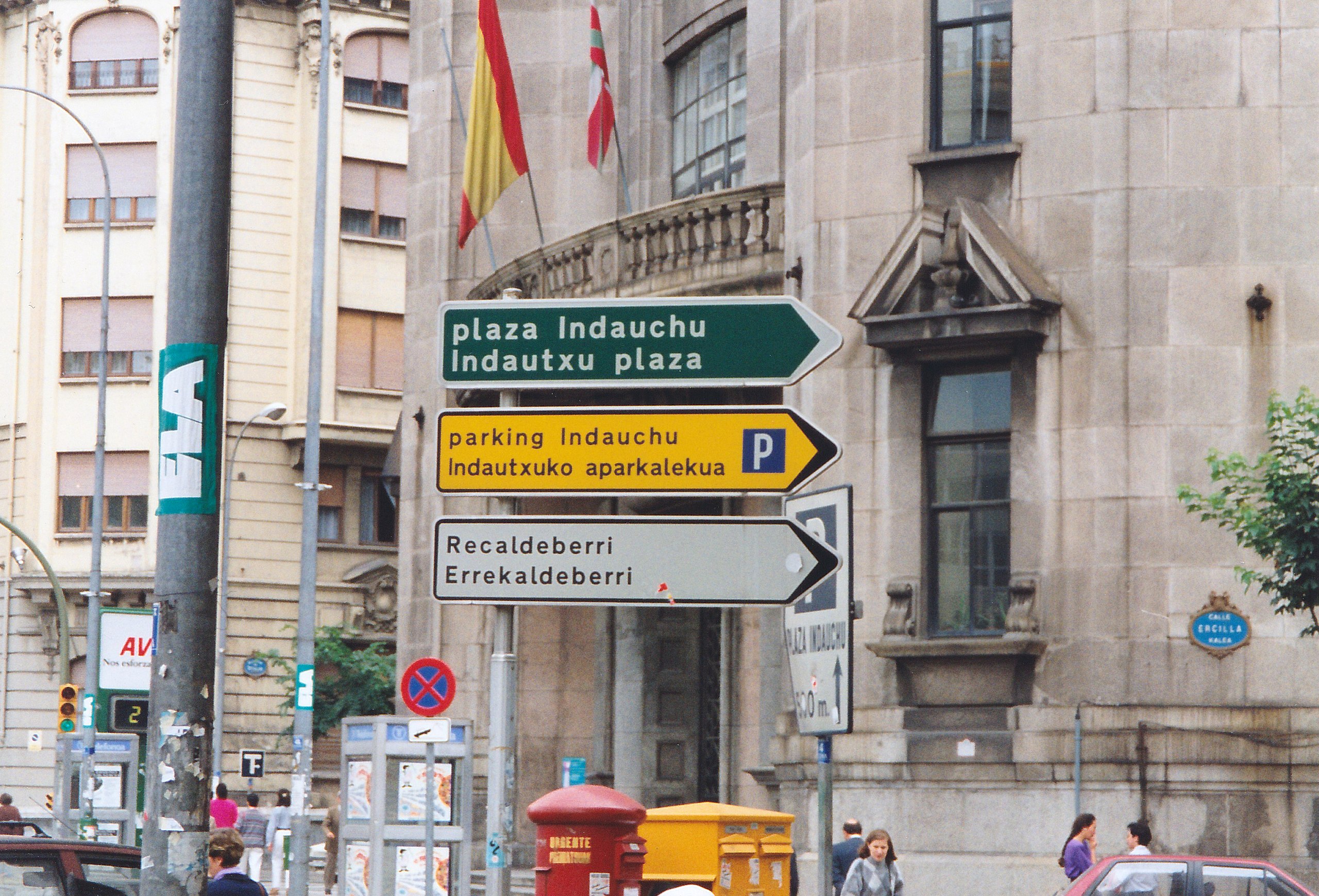 a bunch of street signs on a city street.