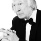 a man in a tuxedo is looking at the camera.