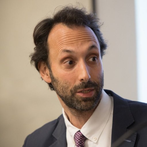a man in a suit and tie looking off into the distance.