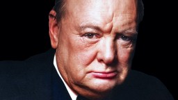 a close up of a person wearing a suit and tie.