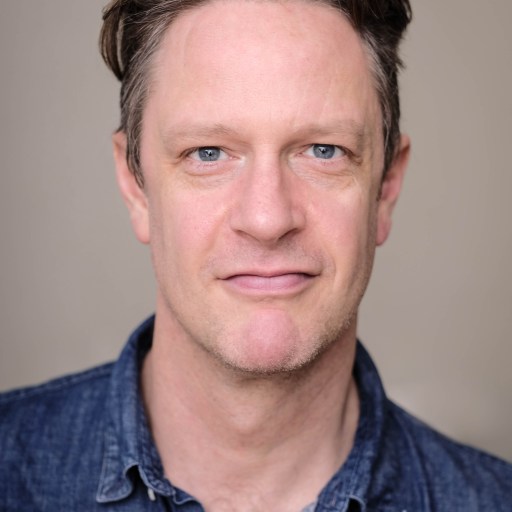 a close up of a person wearing a blue shirt.