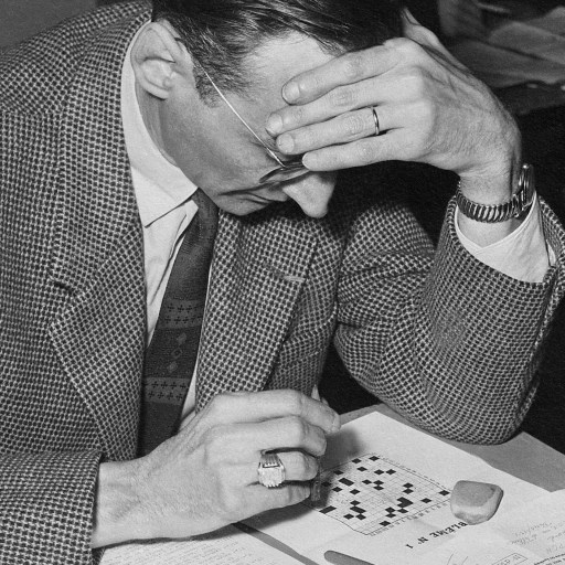 a man sitting at a table with a book in front of him.