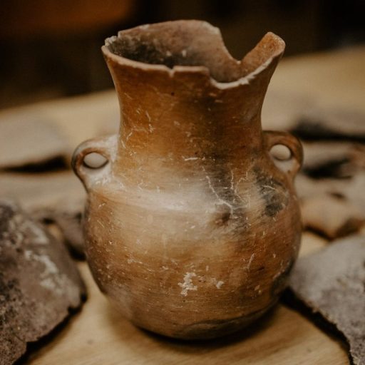 a vase sitting on top of a wooden table.