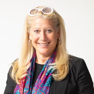 Lisa Miller wearing sunglasses and a colorful scarf.