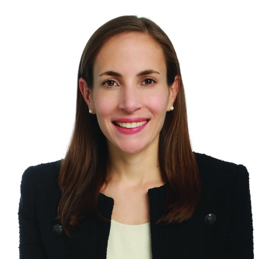 a woman in a black jacket smiling.