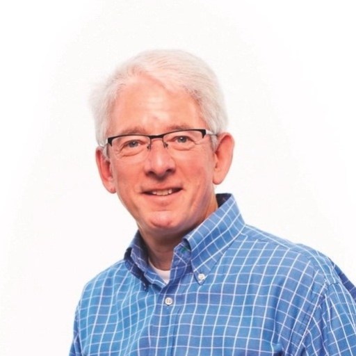 a man wearing glasses and a blue checkered shirt.