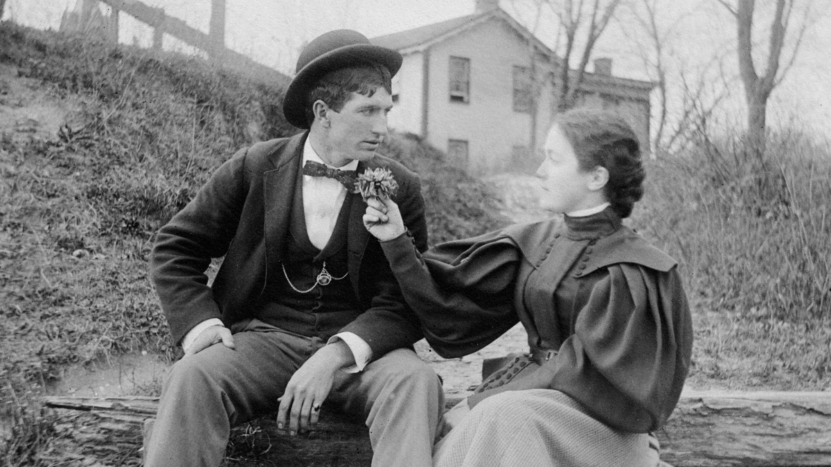 A man and woman reconciling on a log.