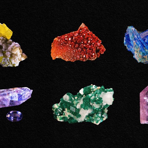 A collection of different colored minerals on a black background.