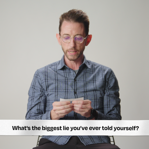 A man is sitting in front of a record player.