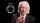 A man in a suit and tie is pointing to a quantum computer.
