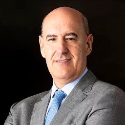 A bald man in a suit and tie.